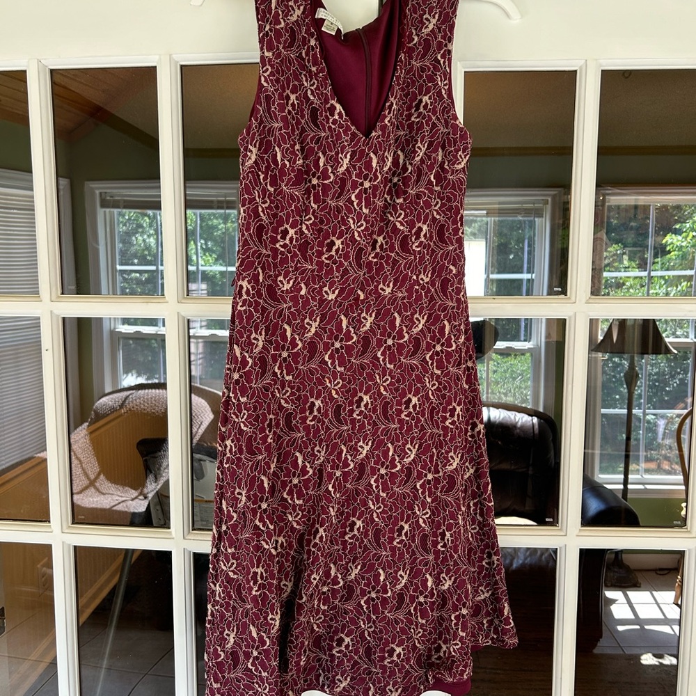 This is a size 8 burgundy and gold dress.